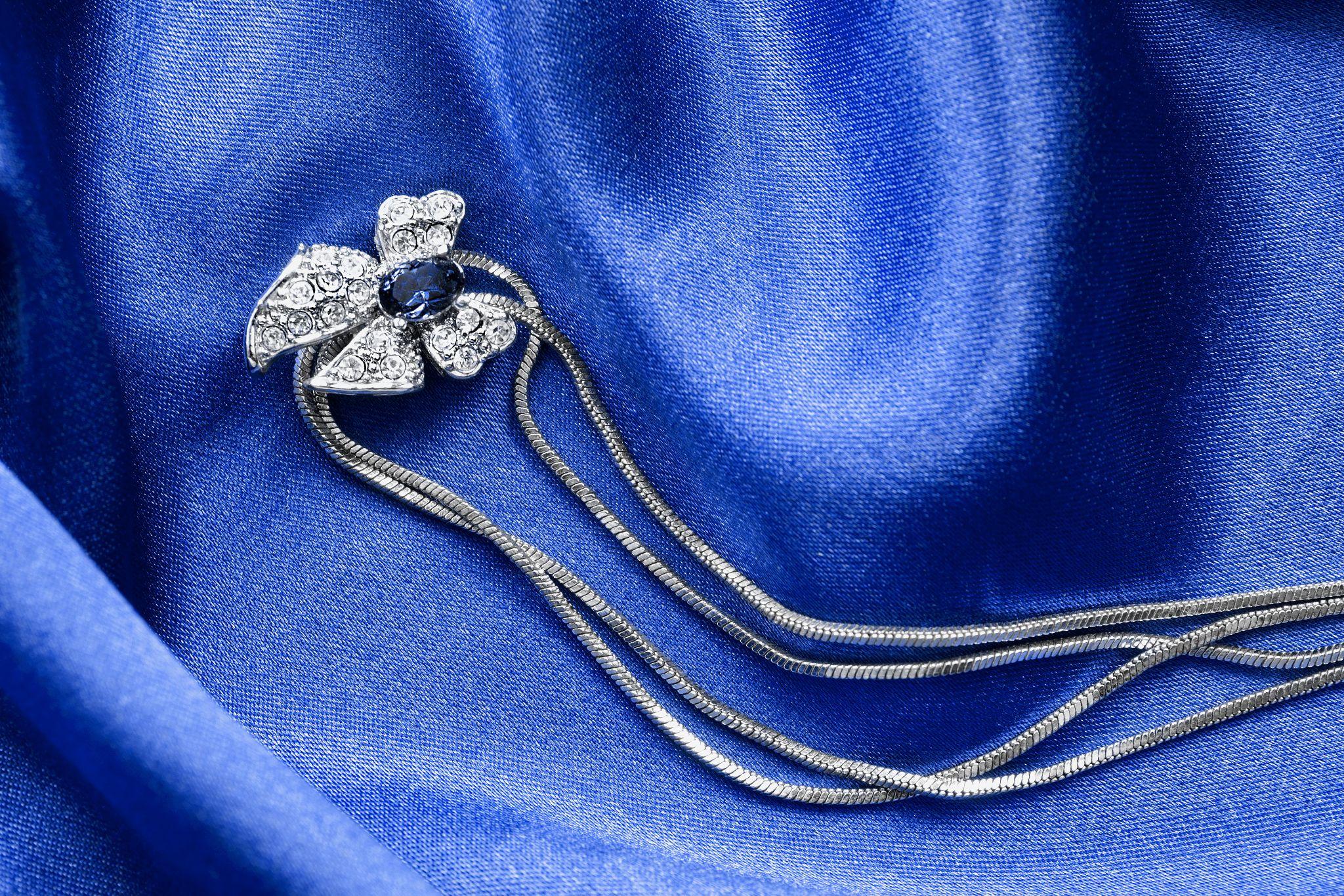 diamond necklace on blue silk