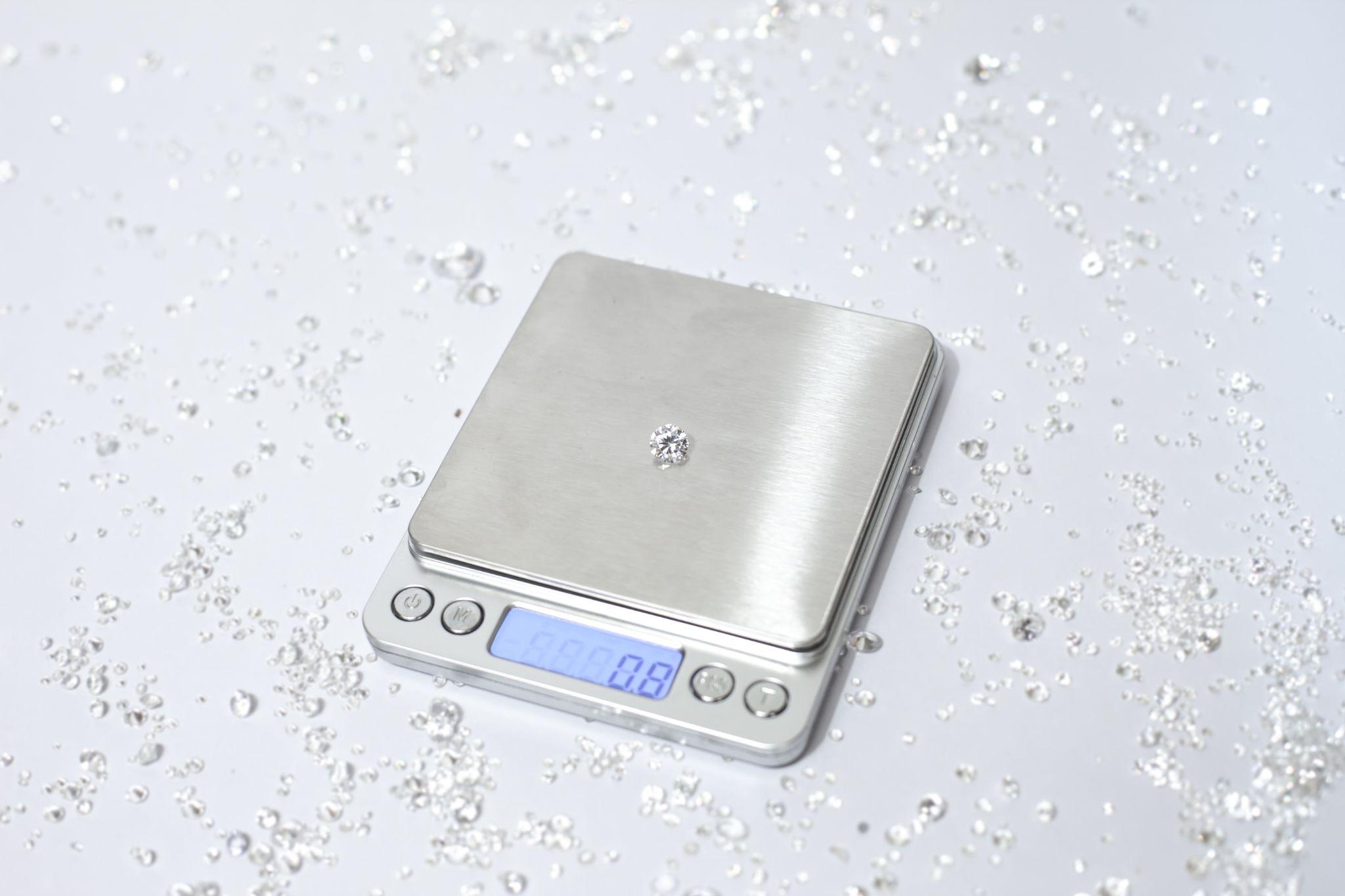 Silver scale with diamond on it.